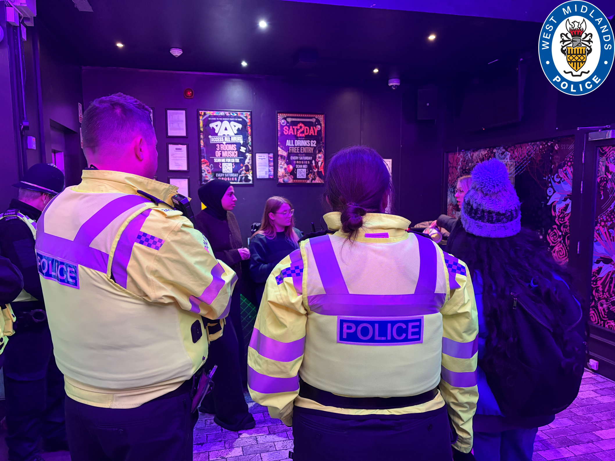 Officers talking with 'the girls group' in a night club